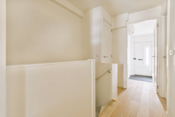 istock A narrow corridor with parquet floors in white colors 1441467733