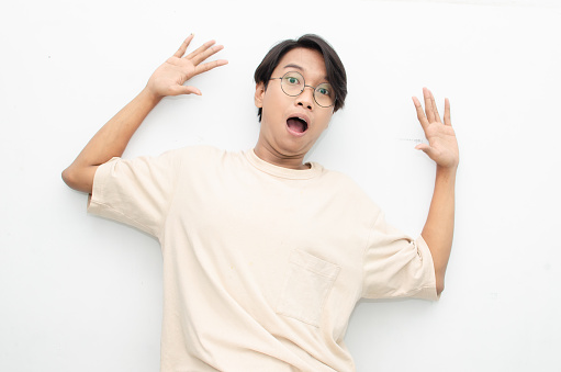 asian man with glasses feels shock with wow surprised expression.