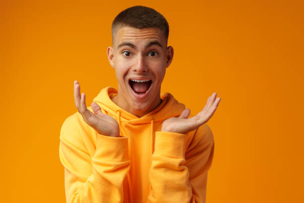 istock Young handsome man shocked with surprise expression standing over yellow background 1441472556