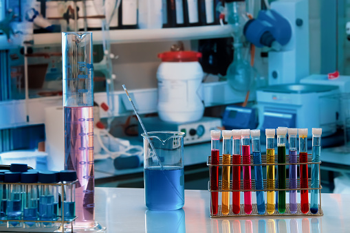 equipment in the lab chemistry researcher workplace. Chemical laboratory work table with cylinders and test tubes