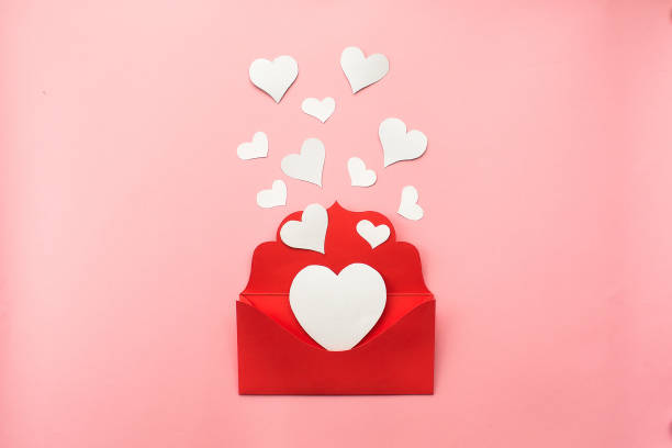 istock Red envelope and white hearts on pink background. Love concept. Saint Valentine's Day concept. Mother's day concept. Flat lay. 1441474764