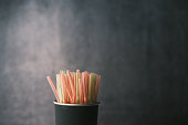 Colored striped bright plastic straws in a jar
