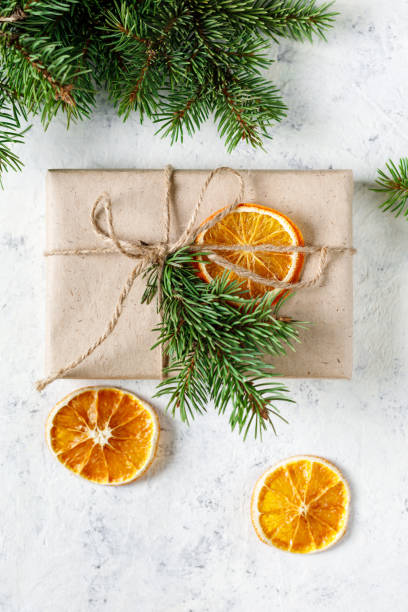 istock Christmas present with dry citruses and fir tree branches on white background. 1441474896