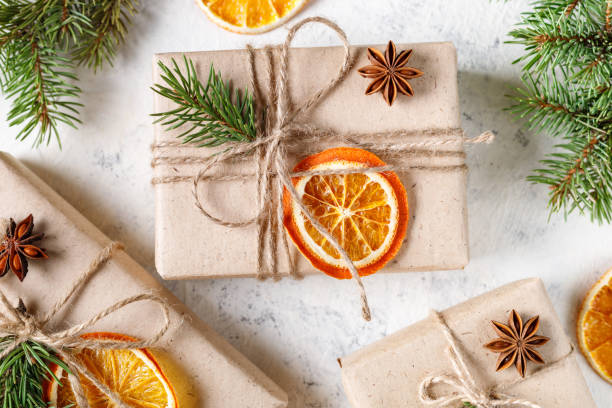 istock Christmas present with dry citruses and fir tree branches on white background. 1441474897