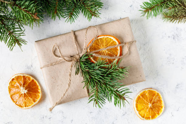 istock Christmas present with dry citruses and fir tree branches on white background. 1441474921