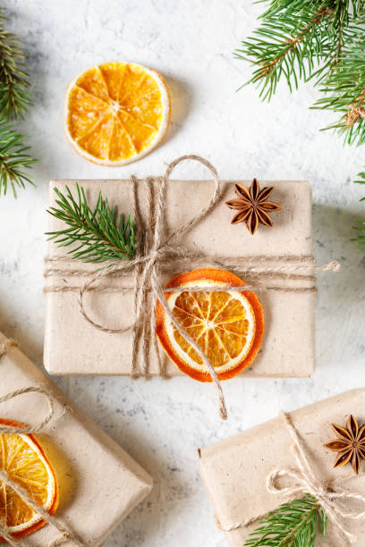 istock Christmas present with dry citruses and fir tree branches on white background. 1441474924
