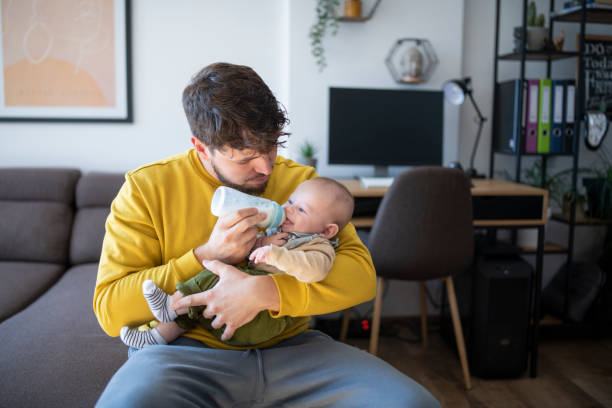 istock Caring father feeding his baby son with bottle. 1441476224