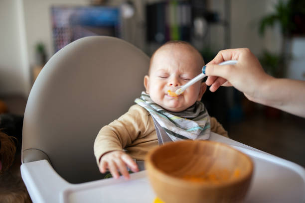 Baby eating puree and not liking it.