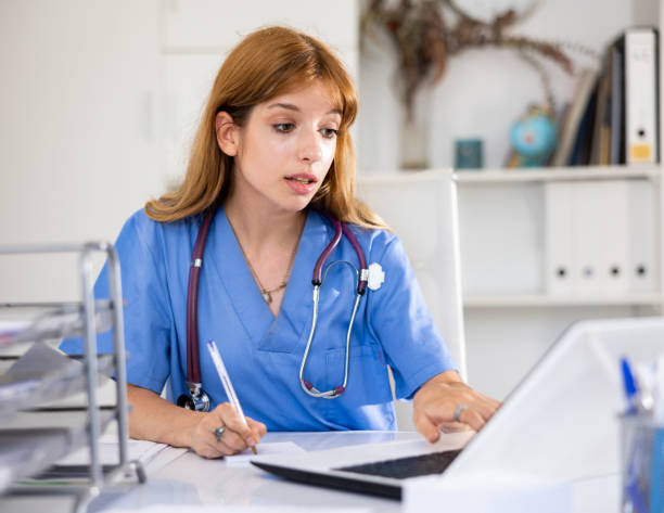 istock Young woman therapist using her laptop in office 1441476462