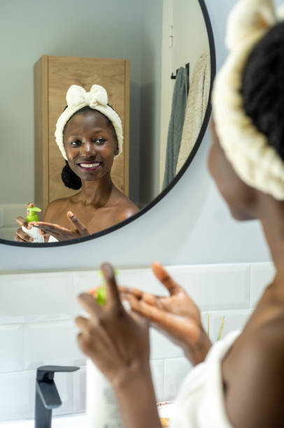 istock woman using cosmetic product 1441476467