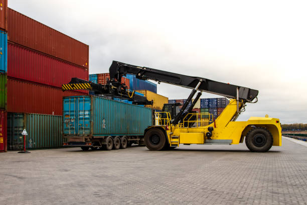 istock Container handlers. Forklift truck in shipping yard. Industrial container logistic yard. Logistics import export concept. 1441478196