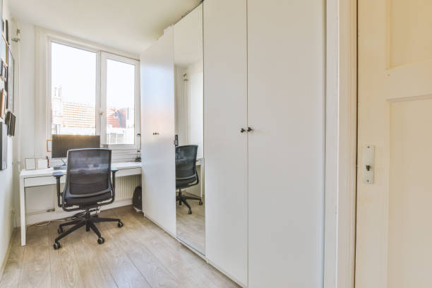 istock A small room with a computer on the table next to a large wardrobe 1441478777