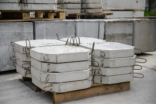 Reinforced concrete slabs for reinforcing road cuvettes, a stack of slabs in a warehouse of a manufacturing enterprise