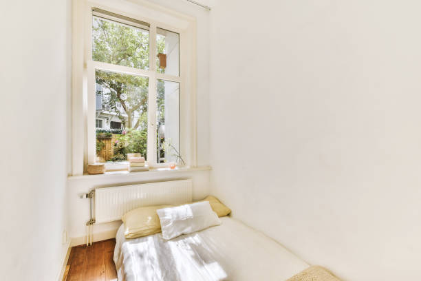 istock A small bedroom in a cozy house with a small bed 1441481298