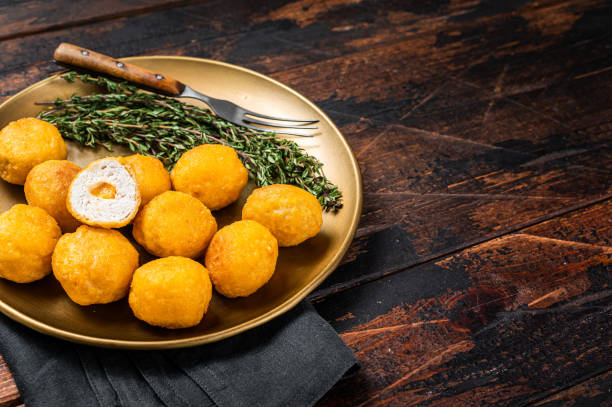 istock Fried crispy round chicken nuggets with Cheese. Wooden background. Top view. Copy space 1441484477