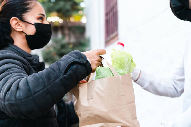 istock Volunteer Delivering Food To Elderly People During Lockdown 1441484731