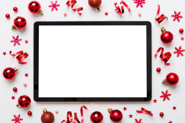 christmas online shopping from home tablet pc with blank white display top view. tablet with copy space on colored background with christmas decorations balls,. winter holidays sales background - decor christmas celebration event christmas ornament imagens e fotografias de stock