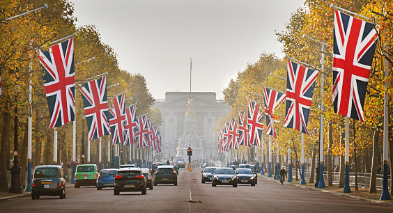 The Mall in London with golden autumn colours and British flags flying for the November birthday of the new King. UK