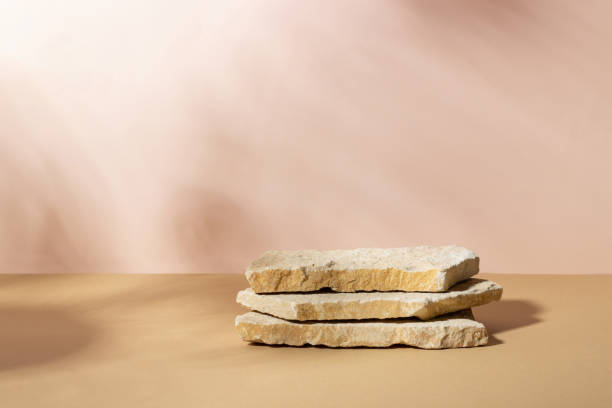 istock Background with an empty stack of stones on a beige background. Stone podium for cosmetic products. Pedestal for product presentation. 1441491782