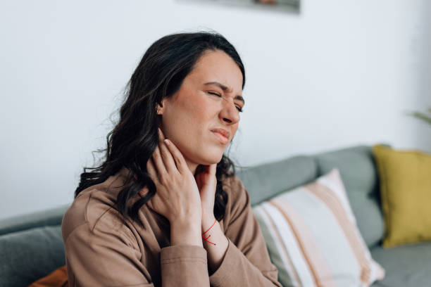istock Woman touching her painful neck 1441493785
