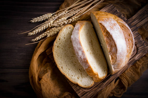 istock Fresh sliced white bread on old wooden background 1441495173