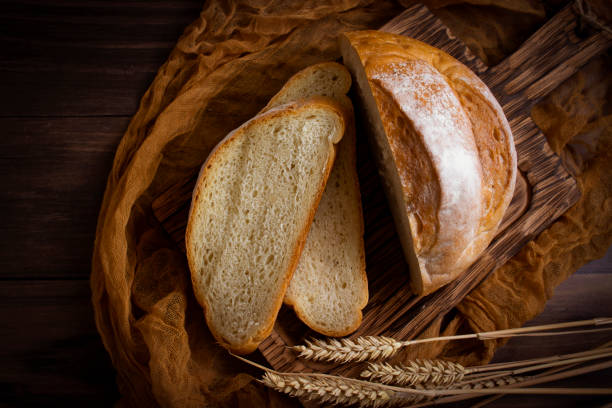 istock Fresh sliced white bread on old wooden background 1441495547