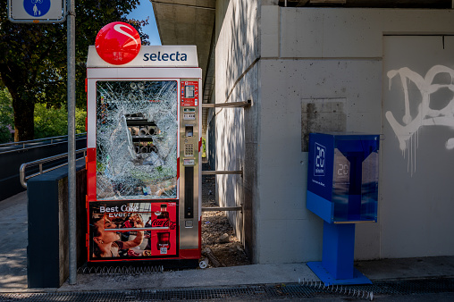 Lausanne, Vaud, Switzerland - September 21, 2022: Damaged Selecta vending machine. Broken glass. Violence concept.