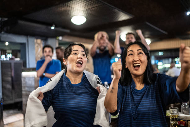 istock Friends rooting for their team and celebrating at bar 1441497106
