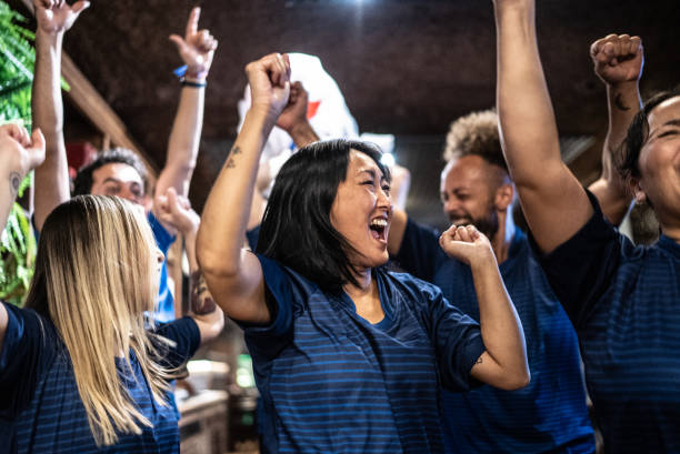 istock Friends rooting for their team and celebrating at bar 1441498225
