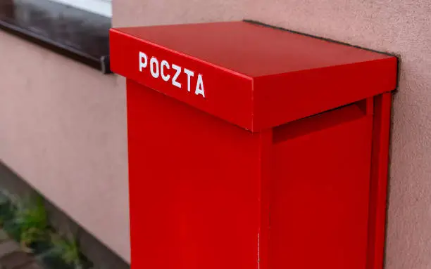 Photo of Red post box in Poland. Typical polish post symbol