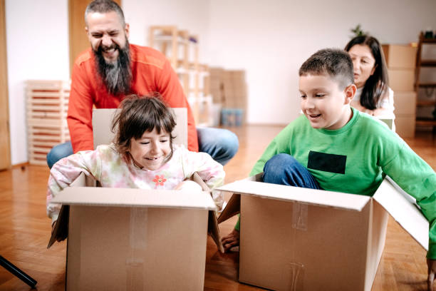 istock Kids playing with parents in new empty apartment 1441498749