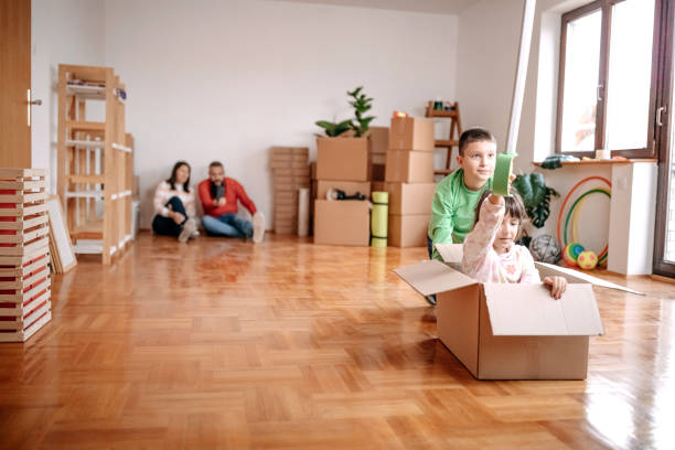 istock Kids playing with parents in new empty apartment 1441499644