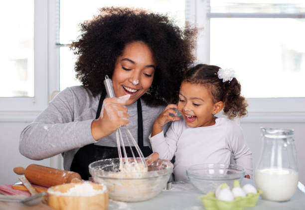 istock Mother and daughter are baking together 1441500843