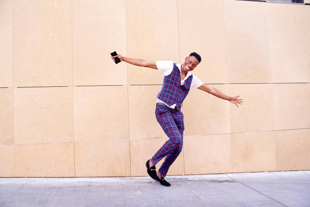 istock smiling and dancing African-American man wearing a suit 1441501363