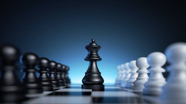 istock 3d rendering, chess game black and white pieces over the blue background. Black queen stands in the middle of the chessboard between two rows of pawns. Politics concept, feminist leadership metaphor 1441501912