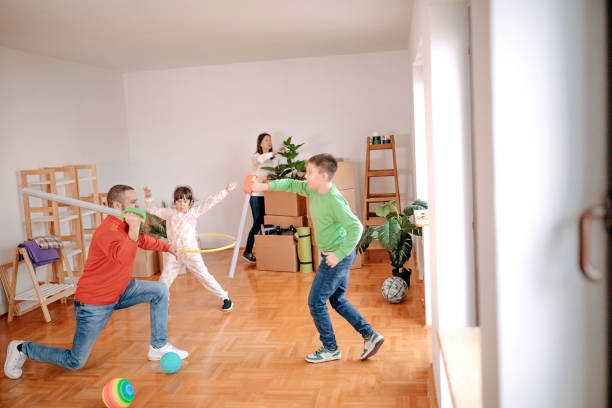 istock Kids playing with parents in new empty apartment 1441502174
