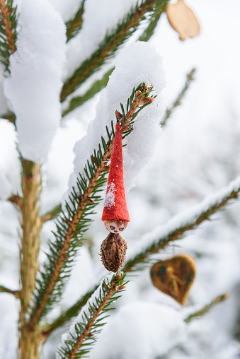 gnome on a snow covered conifer tree