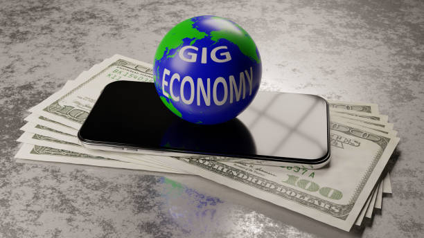 Gig Economy Globe labelled gig economy stacked on top of a cell phone and numerous hundred dollar bills. independence document agreement contract stock pictures, royalty-free photos & images