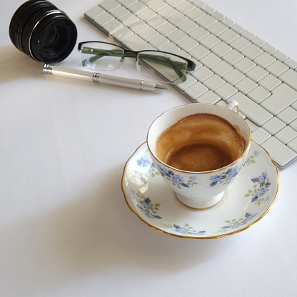 Work table with keyboard, lens, cup of coffee, пен, eyeglasses and sweets, top view