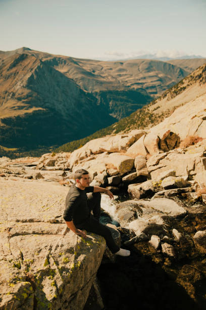 istock Boy looking at an impressive mountain landscape from the top 1441504716