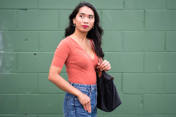 istock Woman portrait against green brick wall. 1441504802