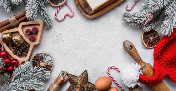 istock A greeting card for Christmas.  Banner with kitchen utensils, Christmas decorations, cinnamon, gingerbread and spruce on a marble background. The concept of cafes and restaurants.Happy New Year 2023. 1441505085