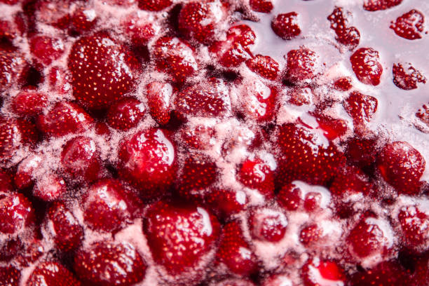 CLOSE UP: Strawberry jam. Make a strawberry jam. Boil strawberries in the pan. Process of cooking, boiling berries for canning. Healthy sweet food. Cooking strawberry jam close up.