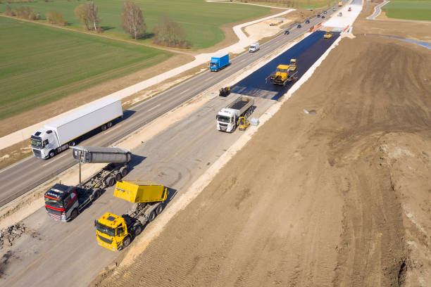 trucks and machinery on road construction site