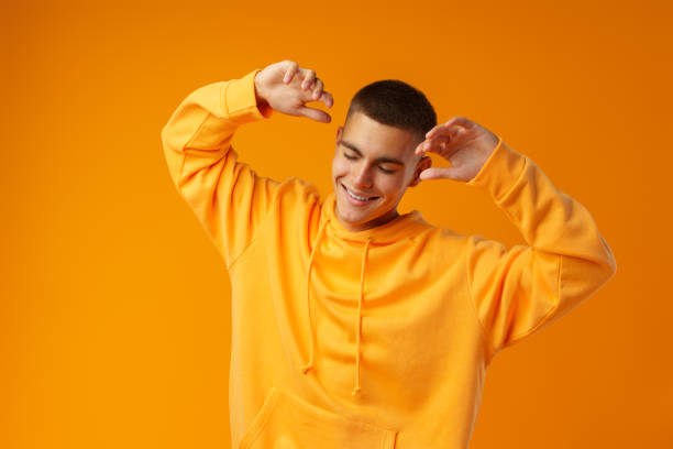 istock Handsome young man dancing near yellow wall 1441510916