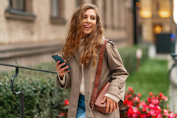 istock Young woman using mobile device standing in the city 1441511070