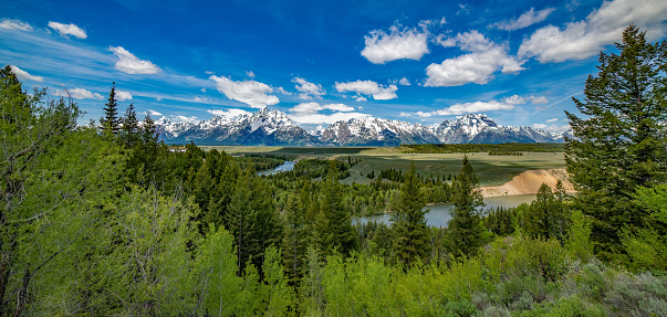 From Snake River overlook wide shot of the Teton range and Grand Teton National Park in northwestern Wyoming USA. Nearby towns are Jackson, Wyoming, Denver, Colorado and Salt Lake City, Utah.