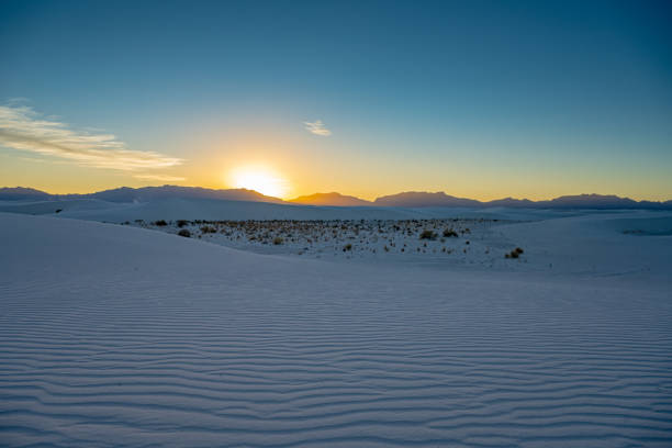 istock Sun Setting Over Camping Area In White Sand Dunes 1441515992