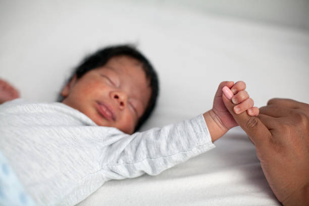 istock Newborn baby securely grasping his mother's finger 1441516462