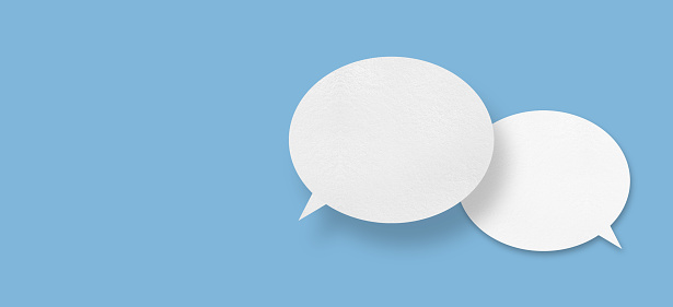 Green and blue speech bubbles. High quality 3D generated image with nice reflections.